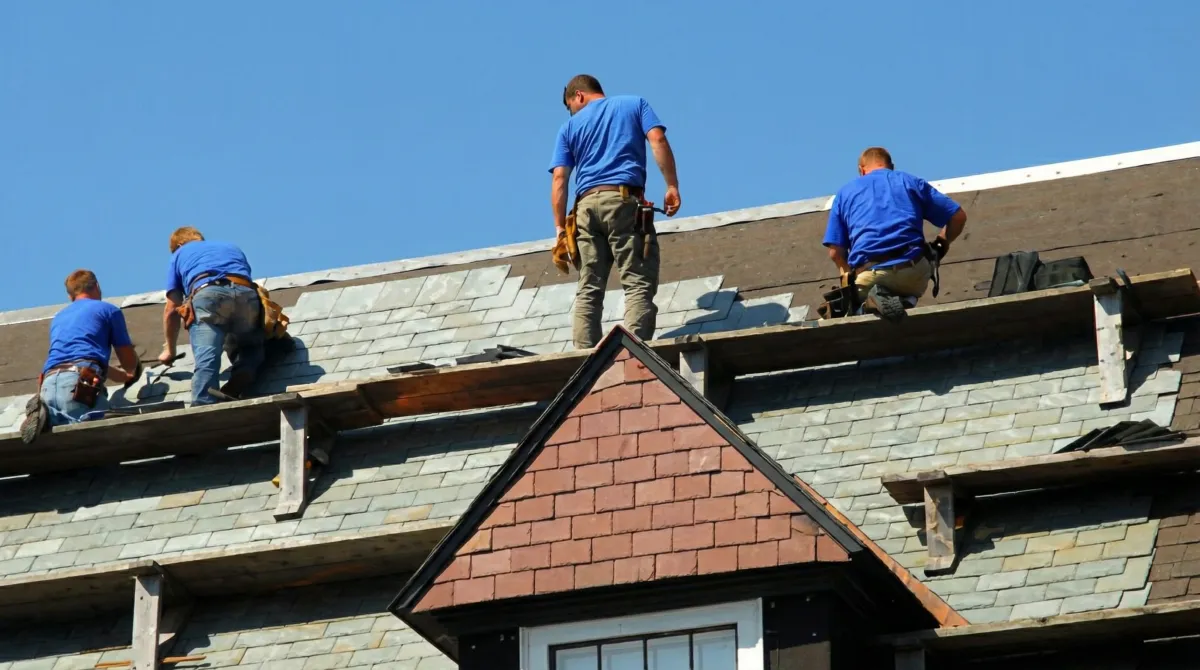 Roof replacement in progress with a team of professional contractors installing new shingles on a residential home in Hollywood, FL